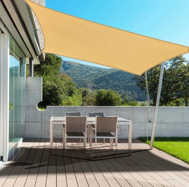 Custom waterproof shade sails over a Melbourne pool, providing heavy-duty sun and rain protection